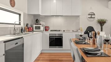 Luxury Townhome | Private kitchen | Full-size fridge, microwave, oven, stovetop
