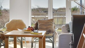 Un espace extérieur accueillant, aménagé avec une table, des chaises et offrant une vue sur le paysage.