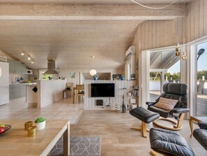 A spacious living area with a kitchen, a flat-screen TV, and a comfortable seating arrangement. - "Claudius" - 1.3km to the fjord by Interhome (Tarm)