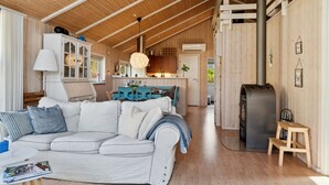 A spacious living area with a sofa, a dining table, and a kitchen in the background. - "Amola" - 1.6km from the sea by Interhome (Højby)