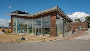 A modern building with large glass windows and a brick facade.