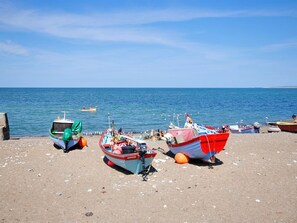 Una playa con varias embarcaciones fondeadas en la orilla.