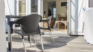 An open door leading to a dining area with a table and chairs. - "Eleen" - 100m to the fjord by Interhome (Vestervig)