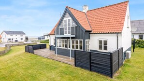 A two-story house with a red-tiled roof, a balcony, and a fenced yard. - "Ima" - 60m from the sea by Interhome (Løkken)