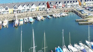 A marina with row houses along the waterfront, boats docked, and a clear view of the sea. - "Halldora" - 10m from the sea by Interhome (Hasle)