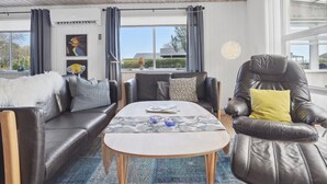 A modern living room with a sofa, armchair, and coffee table. - "Anisa" - 400m from the sea by Interhome (Haderslev)