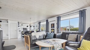A modern living room with a sofa, a coffee table, and a dining area with a table and chairs. - "Anisa" - 400m from the sea by Interhome (Haderslev)