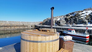A wooden sauna structure with benches and a chimney, located near a dock with a boat. - "Thyrne" - 500m from the sea by Interhome (Gudhjem)