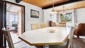 A dining area with a large table, wooden chairs, and a ceiling fan. - "Helmer" - 3km from the sea by Interhome (Østermarie)