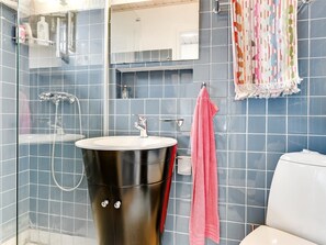 A bathroom with a modern design, featuring a black vanity, a white toilet, and a shower area. - "Mumme" - 100m from the sea by Interhome (Hals)