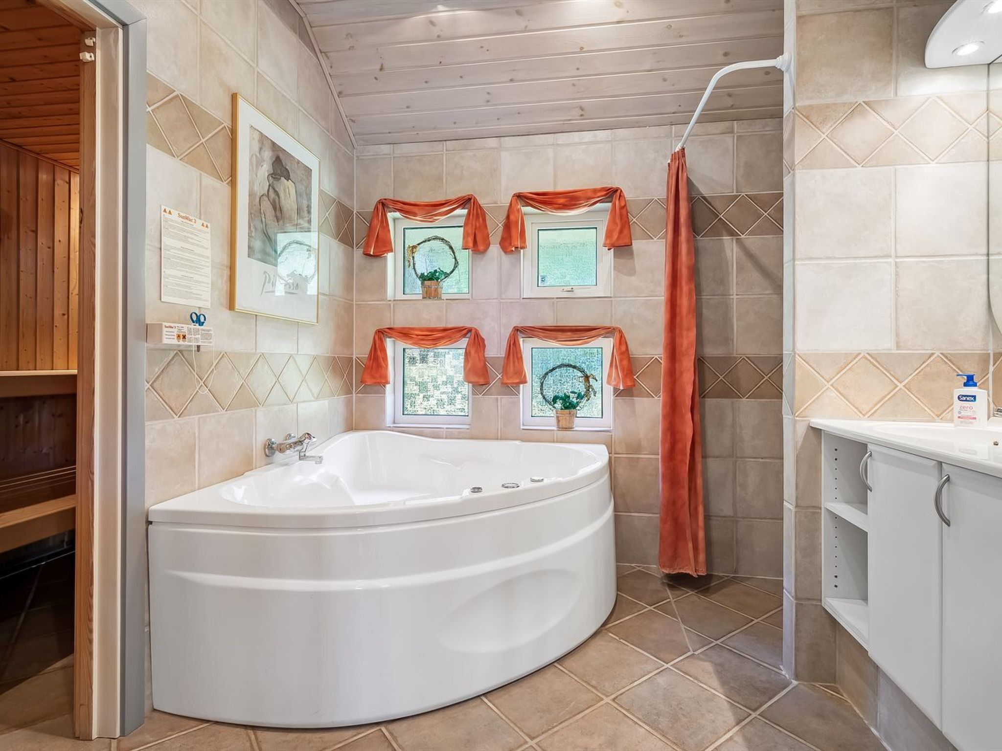 A modern bathroom with a freestanding bathtub, wooden ceiling, and decorative wall panels.