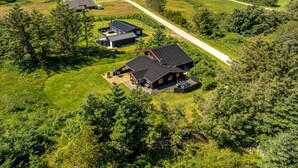 An aerial view of a coastal property with multiple houses, a clear path, and a view of the ocean. - "Gullborg" - 800m from the sea by Interhome (Løkken)