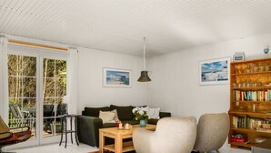 A cozy living room with a sofa, armchairs, a coffee table, and a bookshelf. - "Eimi" - 1.5km from the sea by Interhome (Blokhus)