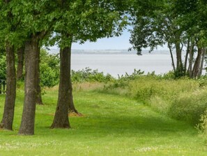 Surrounded by mature trees and a serene lake, this peaceful oasis invites relaxation.