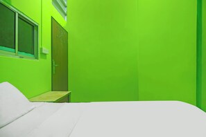 A room with a bed, a window, and a door. - Hotel O Budi Homestay SyariahNearGrand Batam Mall (Batam)