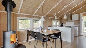 A modern kitchen with a central island, wooden flooring, and a large stove. - "Nafni" - 200m from the sea by Interhome (Væggerløse)