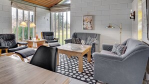 A modern living room with a wooden ceiling, grey sofas, a coffee table, and a polka dot rug. - "Raika" - 450m to the fjord by Interhome (Tarm)