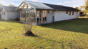 A single-story house with a large glass conservatory attached to the main building. - "Raika" - 450m to the fjord by Interhome (Tarm)