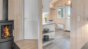 A modern kitchen with a wood-burning stove, a sink, and a window. - "Estella" - 500m to the fjord by Interhome (Hvide Sande)