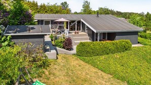 A modern two-story house with a covered patio, a garage, and a well-maintained garden. - "Gerhild" - 300m from the sea by Interhome (Ebeltoft)