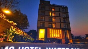 Exterior del hotel M2 Waterside con señalización iluminada y fachada de edificio moderno.