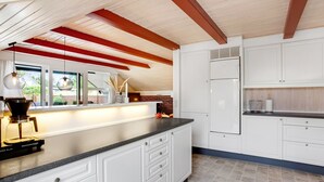 A modern kitchen with white cabinetry, a black countertop, and a built-in oven. - "Görel" - 1km from the sea by Interhome (Blåvand)