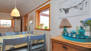 A cozy kitchen with a dining table, chairs, and a window.