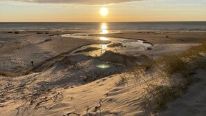 A beach with sand dunes and a sunset over the ocean. - "Halda" - 300m from the sea by Interhome (Vejers Strand)