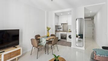 Appartement | Woonruimte | Een 50-inch flatscreentelevisie met kabelzenders