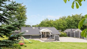 A house with a patio, a covered outdoor seating area, and a fenced yard. - "Thorolf" - 30km from the sea by Interhome (Toftlund)