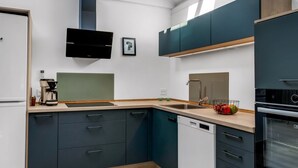 A modern kitchen with dark cabinets, a built-in oven, and a coffee maker. - "Thorolf" - 30km from the sea by Interhome (Toftlund)