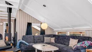 A modern living room with a sectional sofa, a round coffee table, and a fireplace. - "Thorolf" - 30km from the sea by Interhome (Toftlund)