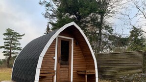 A small, wooden cabin with a pitched roof, a front door, and a wooden deck. - "Ingalise" - 500m from the sea by Interhome (Hals)
