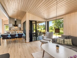 A modern interior with a dining area, a sofa, and a coffee table.