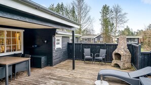 A wooden deck with a grill, outdoor seating, and a stone fireplace. - "Daliborka" - 600m from the sea by Interhome (Hals)