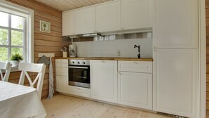 A kitchen with white cabinets, a wooden countertop, a stove, and a sink. - "Gaetana" - 1.6km from the sea by Interhome (Hals)