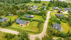 An aerial view of a residential area with houses, green lawns, and a beach in the background. - "Siegrid" - 250m from the sea by Interhome (Hals)