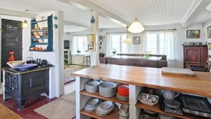 A spacious kitchen with a large wooden table, a stove, and various kitchen utensils. - "Clausina" - 600m from the sea by Interhome (Bredebro)