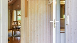 A wooden interior with a door leading to a dining area. - "Frederikke" - 28km from the sea by Interhome (Toftlund)