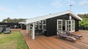 A modern house with a deck, outdoor seating, and a satellite dish. - "Nienke" - 700m from the sea by Interhome (Løkken)