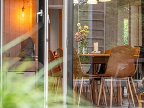 An interior view of a dining area with a table, chairs, and a vase with flowers. - "Ylvi" - 250m from the sea by Interhome (Ebeltoft)