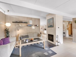 Una sala de estar moderna con un sofá, una mesa de centro y una chimenea.
