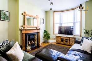 TV, fireplace, books
