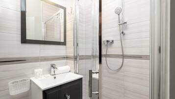 Shower, hair dryer, towels, shampoo