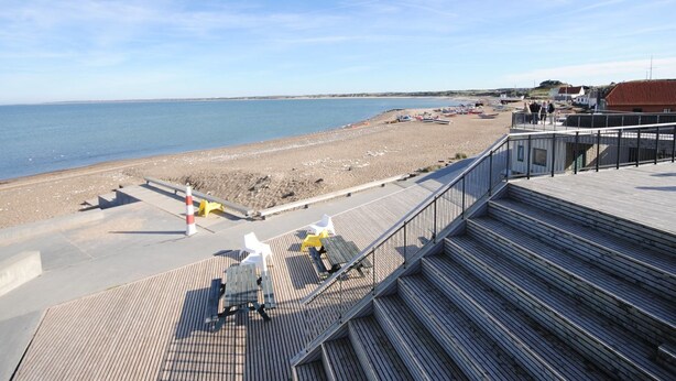 A beach with a wooden boardwalk leading to a sandy shore. - "Helli" - 650m from the sea by Interhome (Thisted)