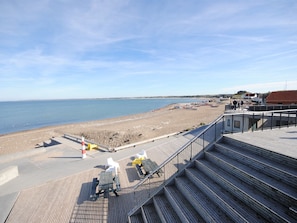 A beach with a wooden boardwalk leading to a sandy shore. - "Helli" - 650m from the sea by Interhome (Thisted)