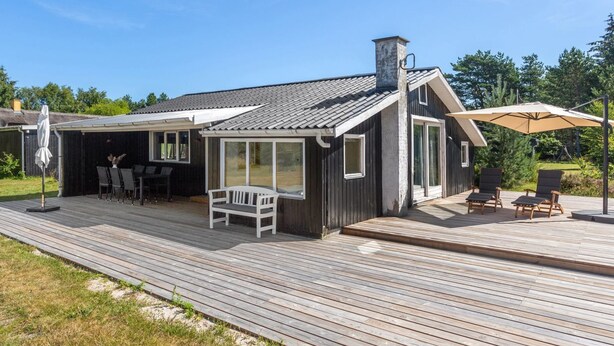 A modern house with a deck, a covered patio, and outdoor seating. - "Landolf" - 250m from the sea by Interhome (Hals)