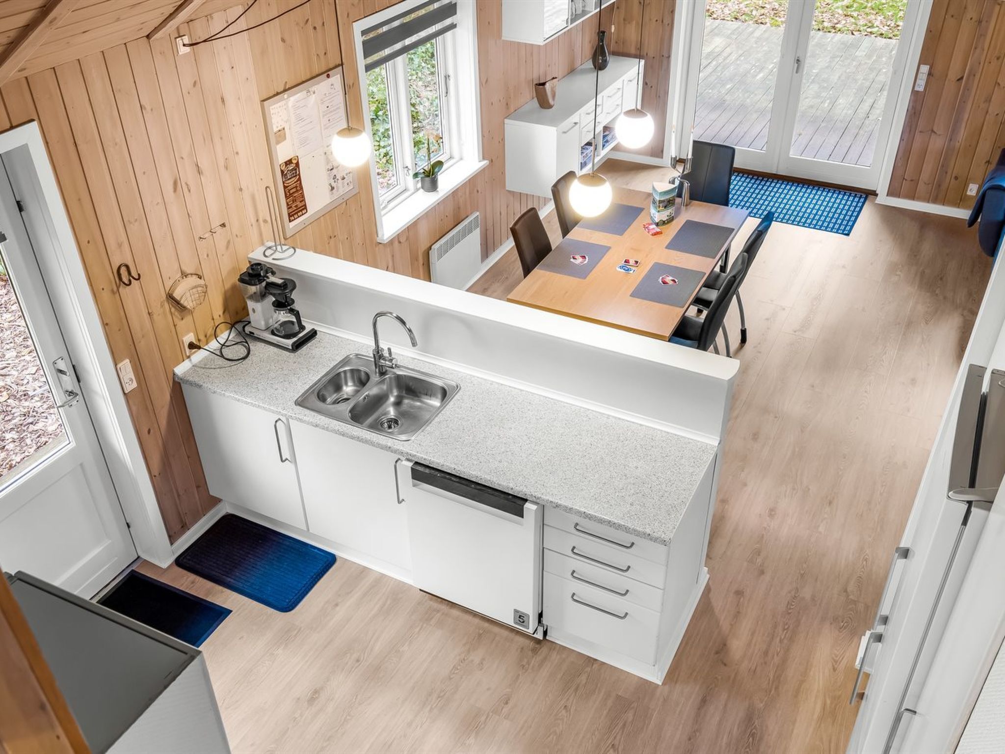 A compact kitchen with a sink, stove, and dining area.