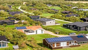 A residential area with modern houses, solar panels, and well-maintained lawns. - "Sulevi" - 200m to the fjord by Interhome (Vestervig)