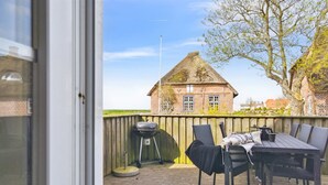 A patio with a table and chairs, a grill, and a basket. - "Adine" - 13km from the sea by Interhome (Bredebro)